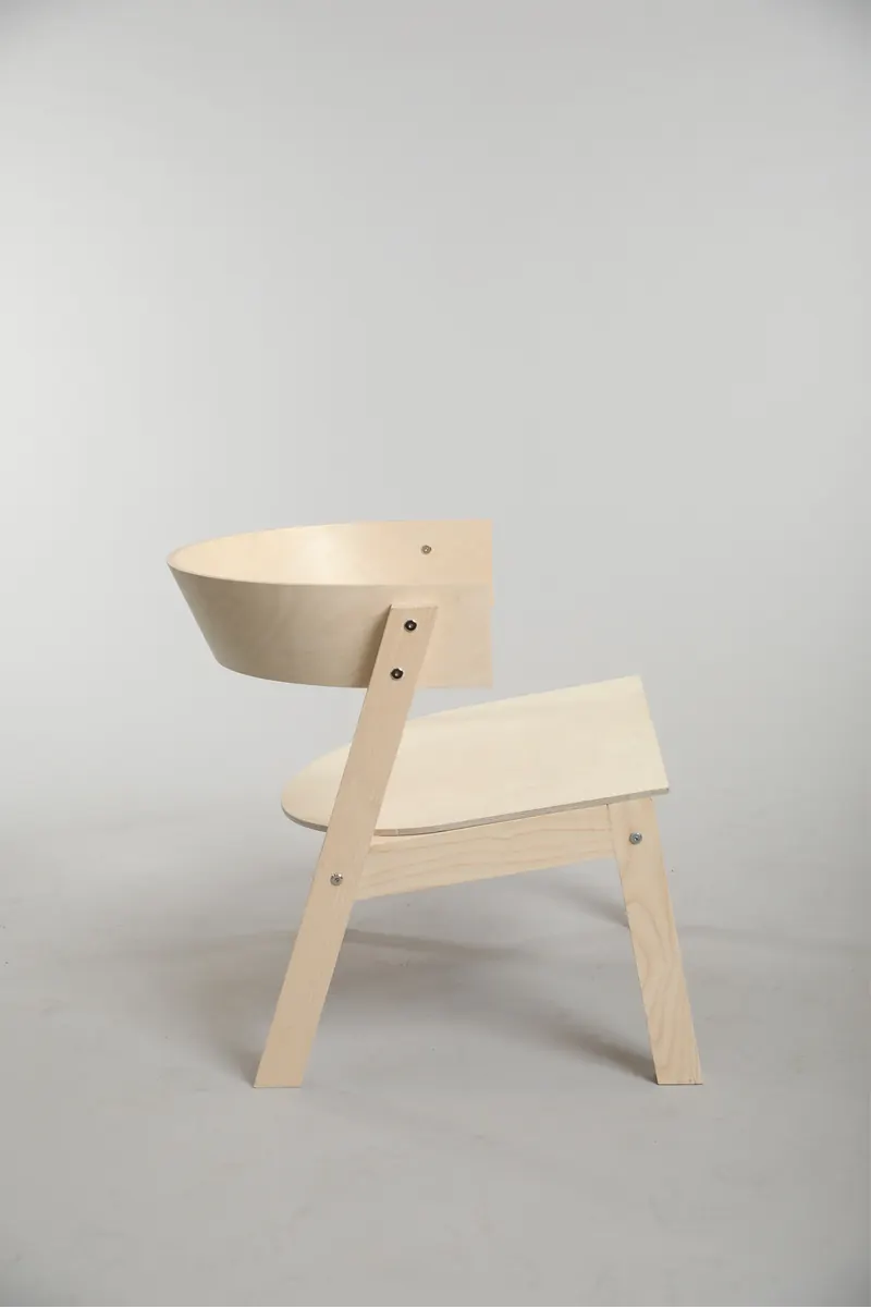 Plywood lounge chair on a gray backdrop